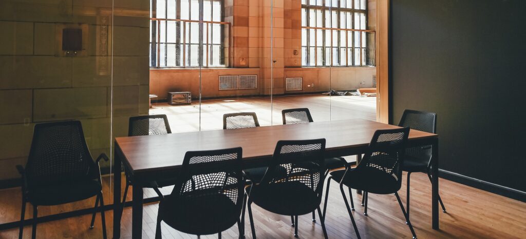 Conference table with empty chairs.